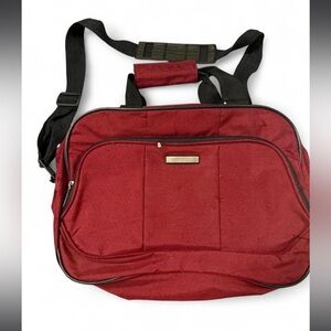 Protege carry-on shoulder bag in a deep red or merlot color